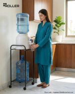 Woman filling a glass from a dispenser on the Roller water stand at hip height, spare 19L bottle stored below
