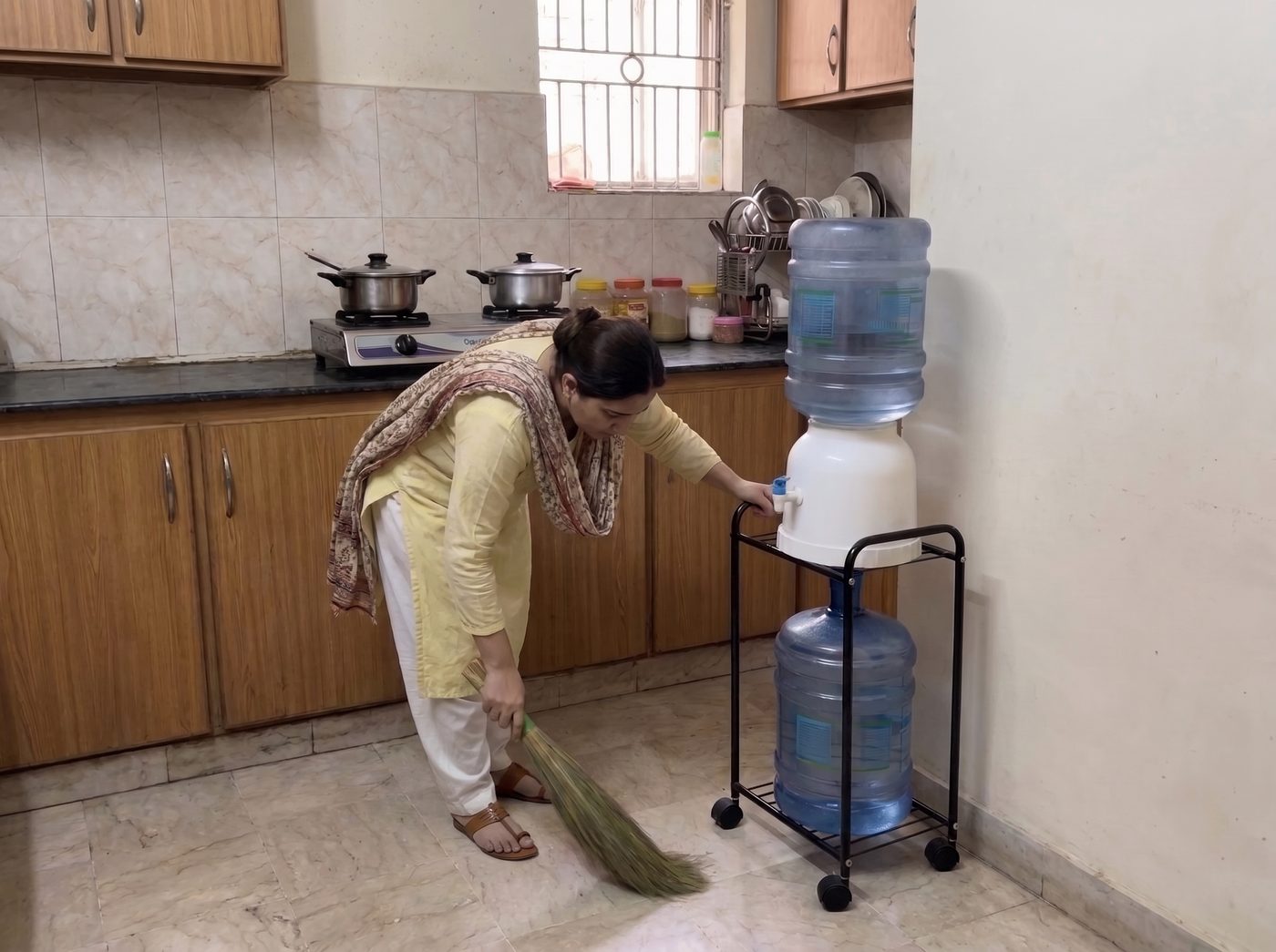 Sweeping the kitchen floor around the Roller water dispenser stand - wheels let it move aside for cleaning